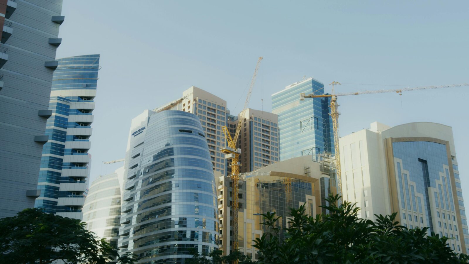Contemporary Skyscrapers Under Construction With Cranes In A Cityscape